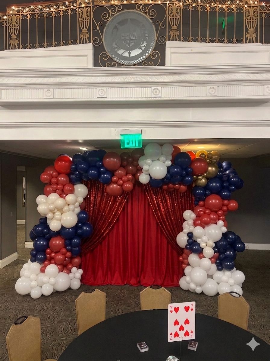 Red white and blue curtain backdrop with balloons