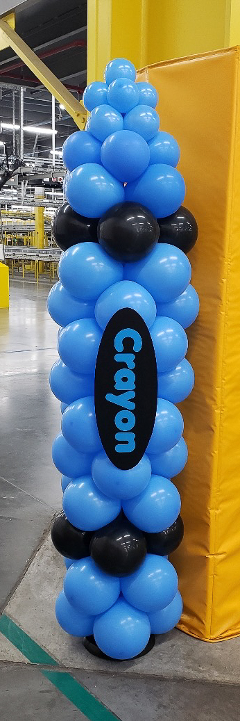 Blue crayon-themed balloon column at an Amazon back-to-school event