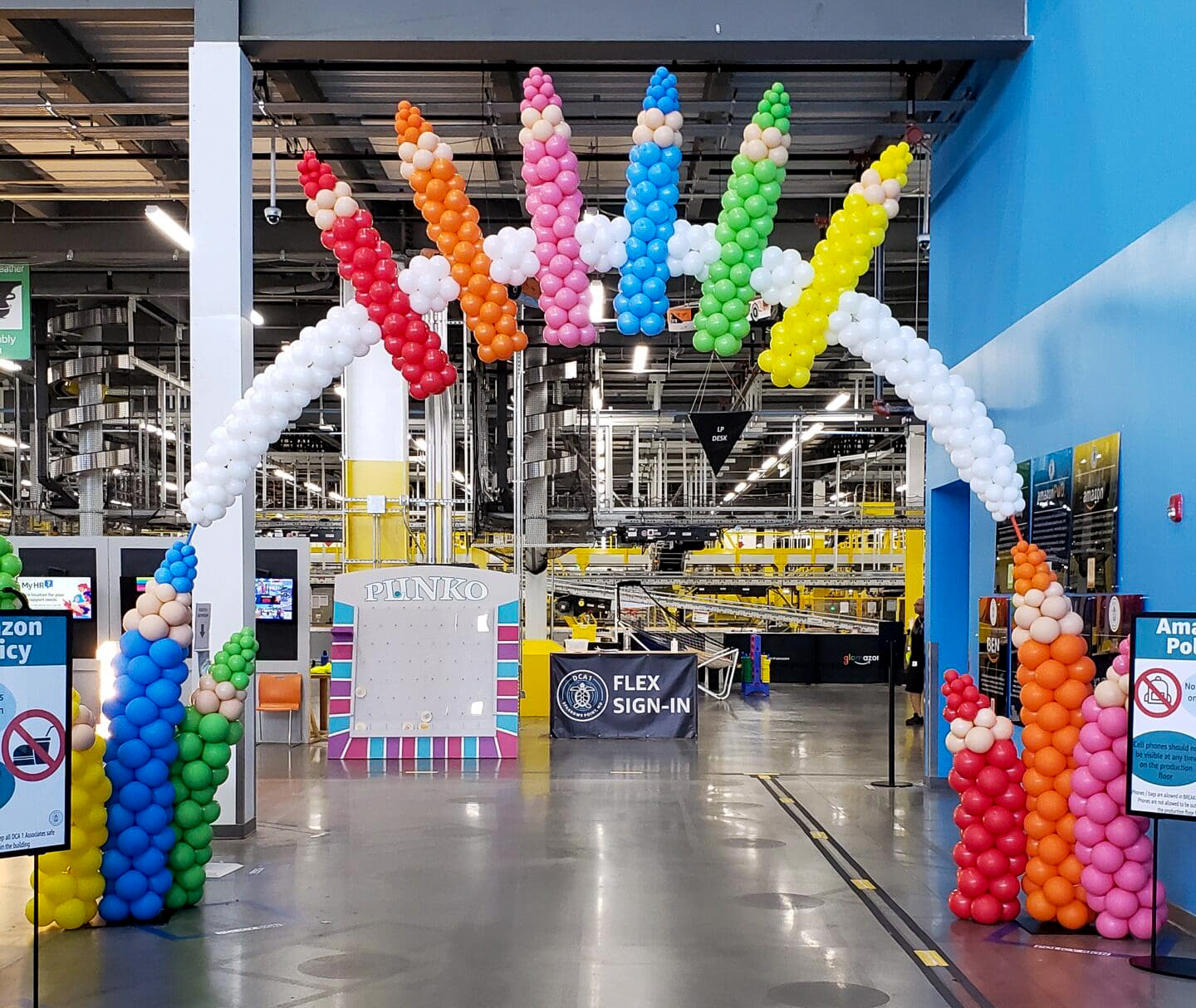 Crayon-themed back-to-school balloon arch at an Amazon fulfillment center