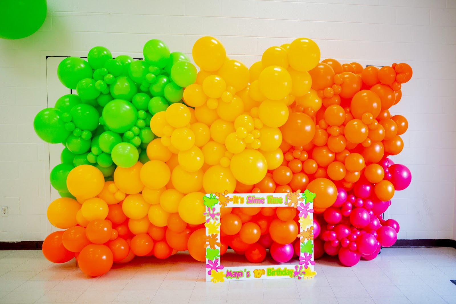 Slime-themed balloon wall by Partistry Balloons