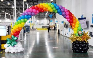 Themed rainbow pot-of-gold balloon arch